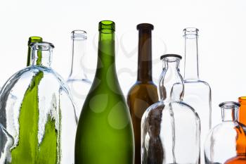 various empty bottles and view of gray sky thought home window glass on background