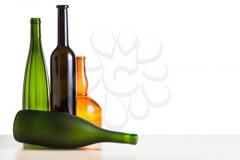 four various empty bottles on wooden table with cutout background