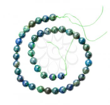 coiled string from polished azurite with malachite balls isolated on white background