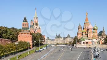 above view of Vasilevsky Descent of Red Square and Kremlin Tower and Vasily the Blessed Cathedral in Moscow city from Bolshoy Moskvoretsky Bridge on sunny autumn day