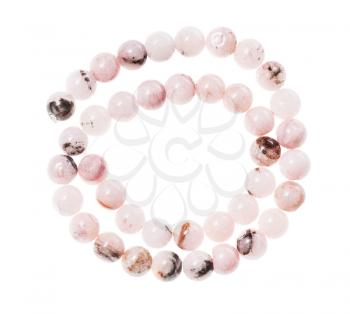 top view of spiral string of round beads from natural cherry blossom rose quartz gemstones isolated on white background