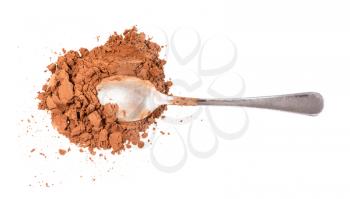 top view of spoon in pile of ground carob powder isolated on white background