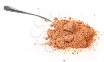 spoon in pile of cocoa powder isolated on white background