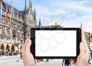 travel concept - tourist photographs of Marienplatz (Mary's Square) in Munich city in Germany on smartphone with empty cutout screen with blank place for advertising