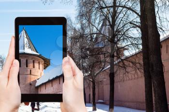 travel concept - tourist photographs of Monastery of Our Savior and St Euthymius in Suzdal town in Russia on smartphone in winter