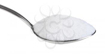 side view of tablespoon with fine ground Sea Salt close up isolated on white background
