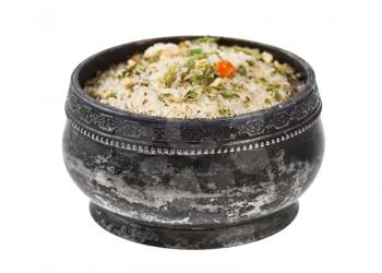 side view of old silver salt cellar with seasoned salt with dried vegetables and flavours isolated on white background