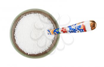 top view of ceramic salt cellar with spoon with grained Rock Salt isolated on white background