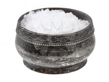 side view of old silver salt cellar with coarse grained Sea Salt isolated on white background
