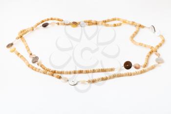 African necklace from natural bone beads on white paper background