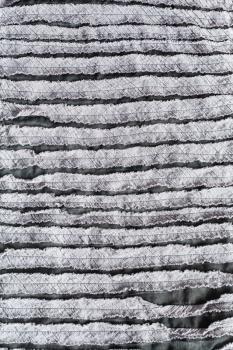 textile vertical background - surface of cloth stitched from carved fabric