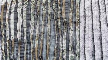 textile panoramic background - surface of scarf stitched from carved fabric