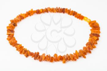 necklace from natural rough amber nuggets on white paper background