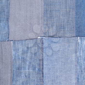 textile square background - patchwork from old denim flaps