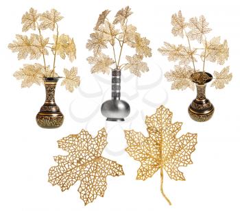 set of leaves and plastic twigs of tree in vases isolated on white background
