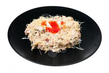 served Quail Nest salad from ham, veal and beef tongue, grated cheese, dressed with mayonnaise and decorated by quail egg and salmon caviar on black plate isolated on white background
