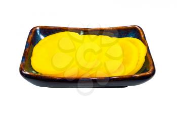 traditional korean and japanese Takuan (Danmuji) side dish from pickled daikon radish in ceramic bowl isolated on white background