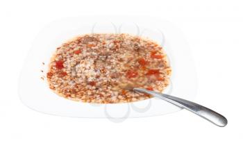 buckwheat soup in white soup plate with spoon isolated on white background