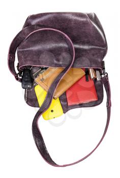 handcrafted soft ladies leather bag with dropped contents isolated on white background