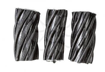 few coiled black licorice candies isolated on white background