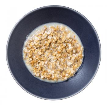 top view of cooked porridge from wholegrain oat in gray bowl isolated on whitte background