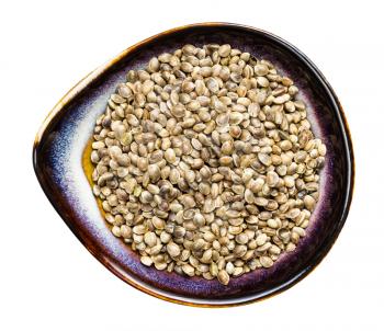 top view of hemp seeds in ceramic bowl isolated on white background