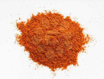 top view of pile of chili powder from cayenne pepper close up on gray ceramic plate