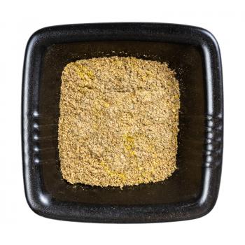 top view of georgian khmeli suneli flavoring in black bowl isolated on white background