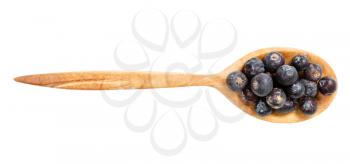 top view of wood spoon with dried juniper berries isolated on white background