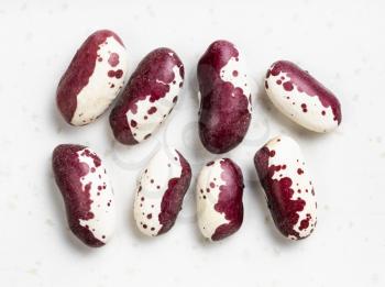 several red speckled kidney beans close up on gray ceramic plate