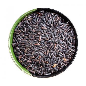 top view of raw black rice in round bowl isolated on white background