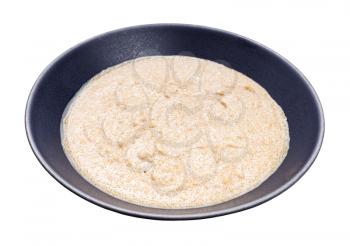 porridge from amaranth grains and coconut milk in gray bowl isolated on white background