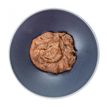 top view of boiled porridge from teff grains in gray bowl isolated on white background