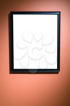 vertical narrow black picture frame with cutout canvas on red brown wall