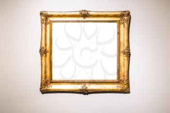 old wide baroque gold picture frame with cutout canvas on brown gray wall