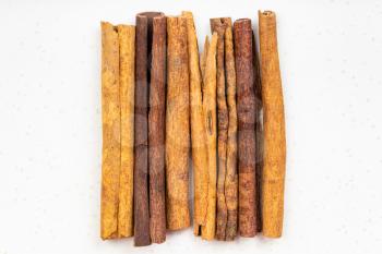 top view of several sticks of cassia cinnamon close up on gray ceramic plate