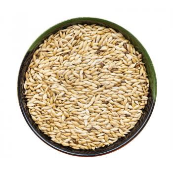 top view of scagliola canary seeds in round bowl isolated on white background