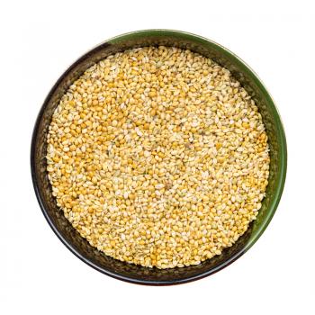 top view of whole-grain foxtail millet seeds in round bowl isolated on white background