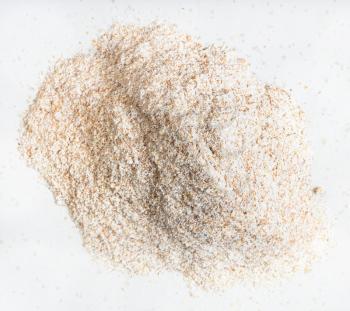 top view of pile of whole-grain wheat flour close up on gray ceramic plate