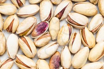 food background - many shelled and ripe pistachio nuts