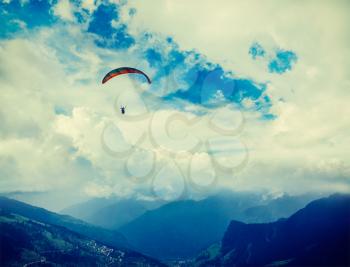 Vintage retro effect filtered hipster style travel image of freedom flight concept - paraplane in sky above Himalayas mountains