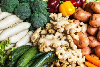 Vegetables in Asian market close up - zucchini, Capsicum bell peppers, potatoes, ginger, broccoli  cabbage,  daikon white radish