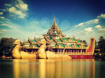 Vintage retro effect filtered hipster style image of Yangon icon landmark and tourist attraction Karaweik - replica of a Burmese royal barge at Kandawgyi Lake, Yangon, Myanmar Burma