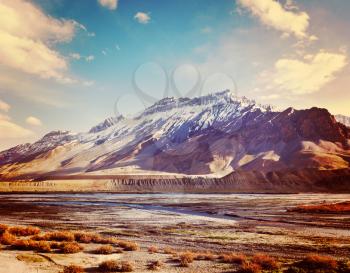 Vintage retro effect filtered hipster style travel image of Spiti Valley -  snowcapped Himalayan Mountains. Himachal Pradesh, India
