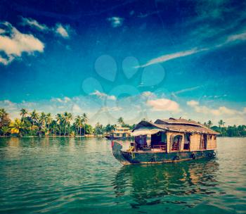 Vintage retro hipster style travel image of travel tourism Kerala background - houseboat on Kerala backwaters with grunge texture overlaid. Kerala, India