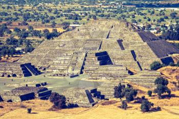 Vintage retro hipster style travel image of Pyramid of the Moon. View from the Pyramid of the Sun. Teotihuacan, Mexico