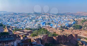 Aerial panorama of Jodhpur, also known as Blue City due to the vivid blue-painted Brahmin houses. View from Mehrangarh Fort (part of fortifications is also visible).  Jodphur, Rajasthan, India