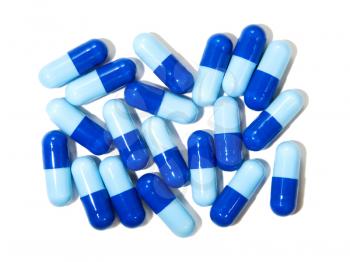 Blue drug capsule isolated on white background.