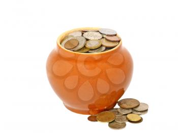 Old ceramic pot with metal money isolated on a white background.