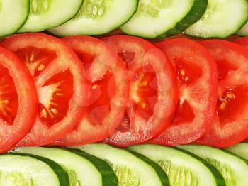 Slices of tomato and cucumber arranged in a row suitable as background.